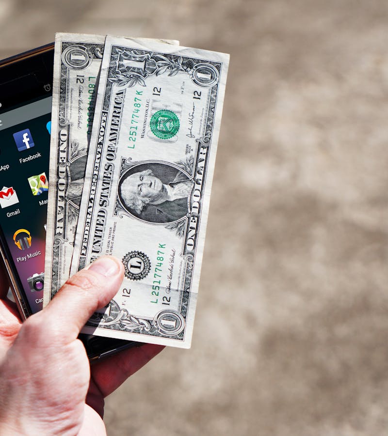 mobile-phone-money-banknotes-us-dollars-163069